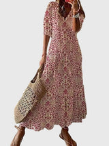 Women's vintage boho summer dress with floral print, V-neck and flowy maxi skirt