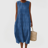 Elegant sleeveless midi dress with side pockets and lightweight fabric for women, comfortable and versatile for summer or everyday wear