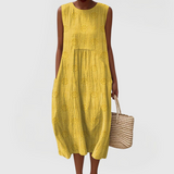 Elegant sleeveless midi dress with side pockets and lightweight fabric for women, comfortable and versatile for summer or everyday wear
