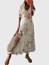 Women's vintage boho summer dress with floral print, V-neck and flowy maxi skirt