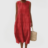 Elegant sleeveless midi dress with side pockets and lightweight fabric for women, comfortable and versatile for summer or everyday wear