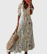 Women's vintage boho summer dress with floral print, V-neck and flowy maxi skirt