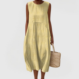 Elegant sleeveless midi dress with side pockets and lightweight fabric for women, comfortable and versatile for summer or everyday wear