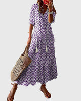 Women's vintage boho summer dress with floral print, V-neck and flowy maxi skirt