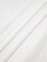 Women's white oversized shirt with structured shoulders and V-neck