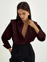 Women's white oversized shirt with structured shoulders and V-neck