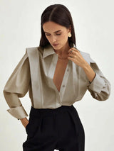 Women's white oversized shirt with structured shoulders and V-neck