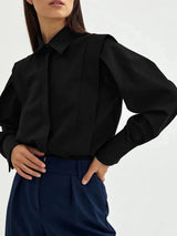 Women's white oversized shirt with structured shoulders and V-neck