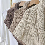 Triangular knitted scarf with leather buckle