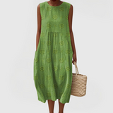 Elegant sleeveless midi dress with side pockets and lightweight fabric for women, comfortable and versatile for summer or everyday wear