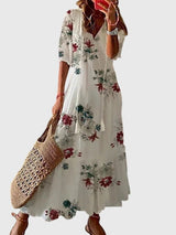 Women's vintage boho summer dress with floral print, V-neck and flowy maxi skirt