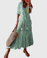 Women's vintage boho summer dress with floral print, V-neck and flowy maxi skirt