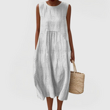 Elegant sleeveless midi dress with side pockets and lightweight fabric for women, comfortable and versatile for summer or everyday wear