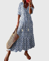 Women's vintage boho summer dress with floral print, V-neck and flowy maxi skirt