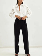 Women's white oversized shirt with structured shoulders and V-neck