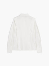 Women's white oversized shirt with structured shoulders and V-neck