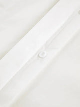 Women's white oversized shirt with structured shoulders and V-neck