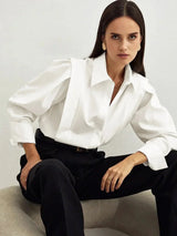 Women's white oversized shirt with structured shoulders and V-neck