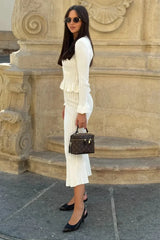 Women's fitted outfit with cardigan and midi skirt